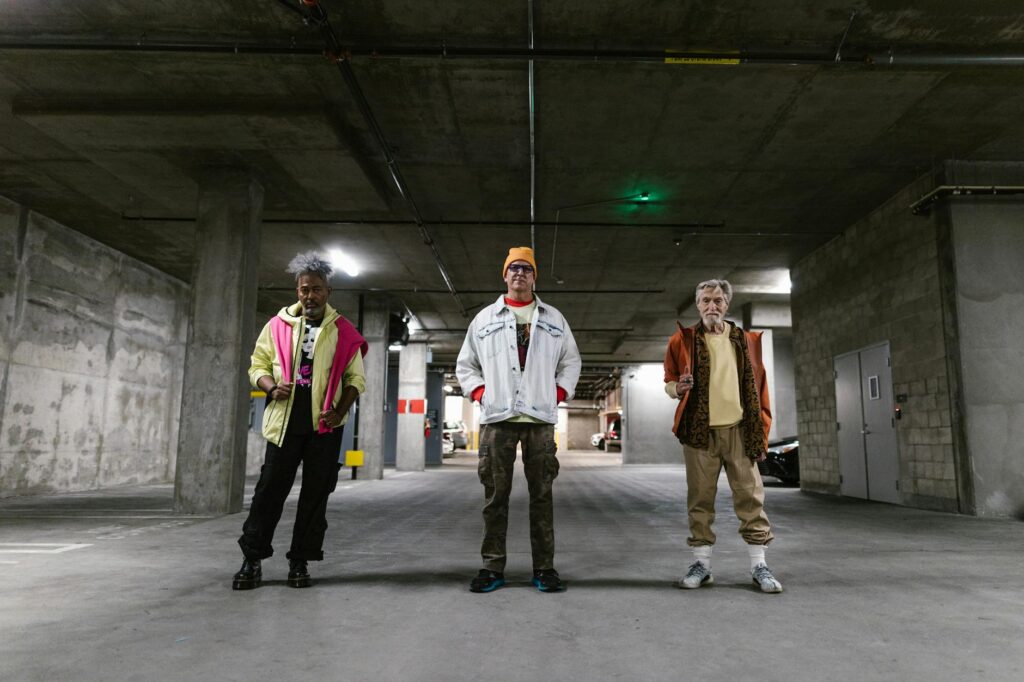 Diverse_group_of_men_showcasing_street_fashion_in_an_urban_parking_garage._Trendy_outfits_and_distinctive_styles..RDNE_Stock_project