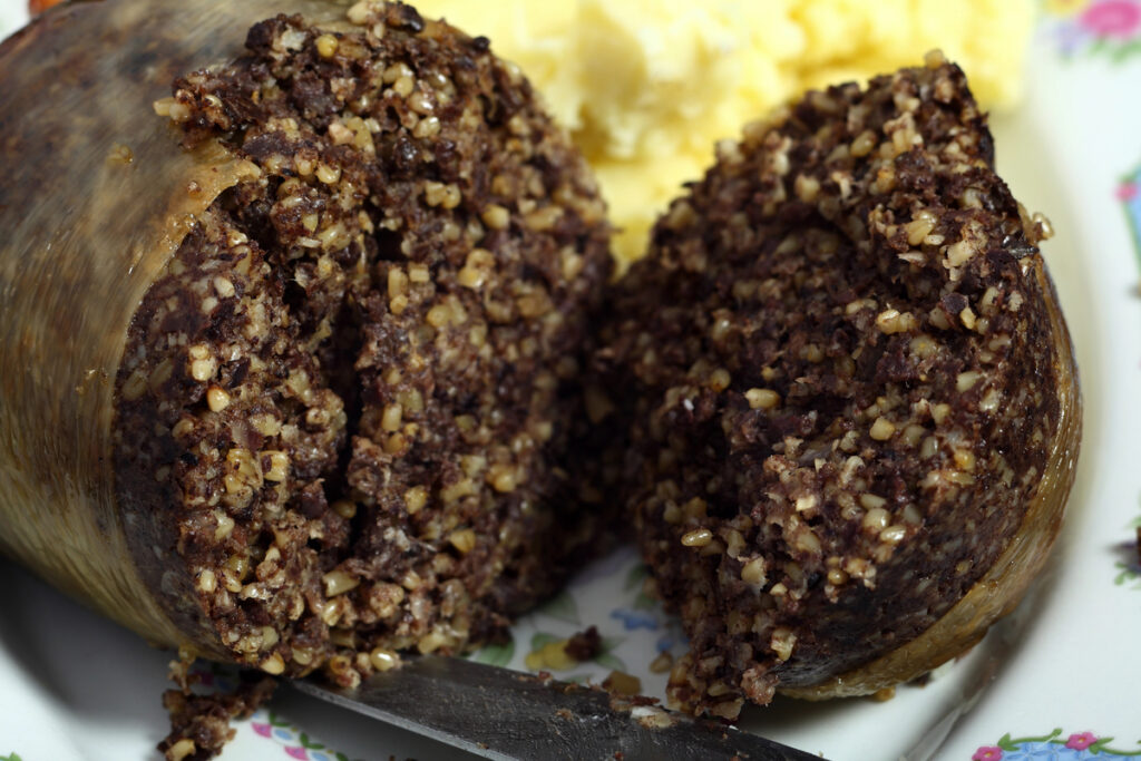 View of a cooked scottish haggis that has been sliced open.