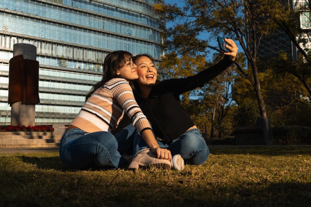 Young Women Taking a Selfie Outdoors in Urban Park