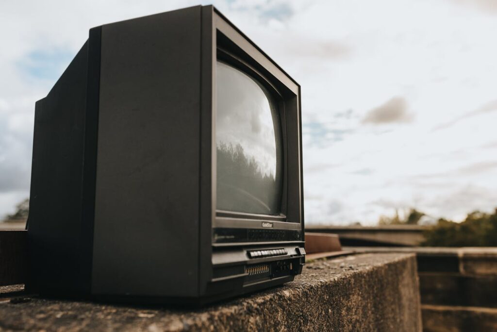 Old TV set placed on concrete fencing