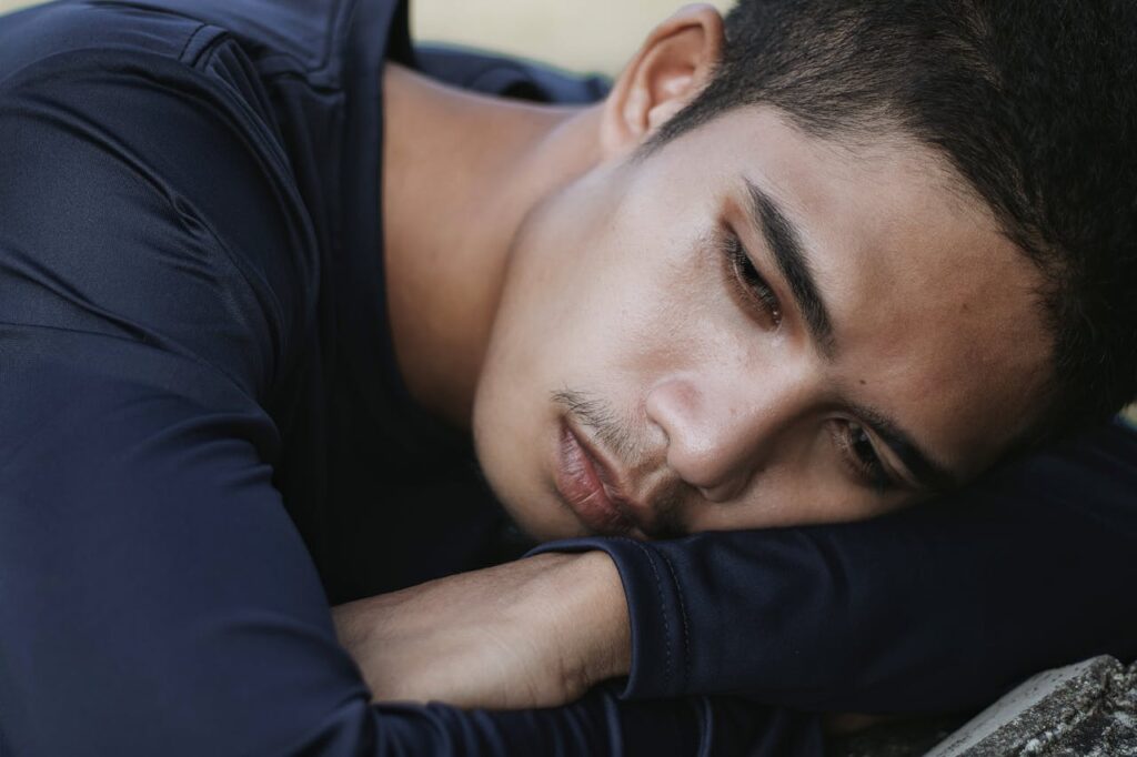 An Emotional Man Leaning on His Arms