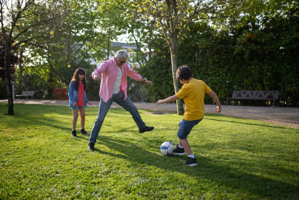A Man Playing Soccer with His Grandchildren