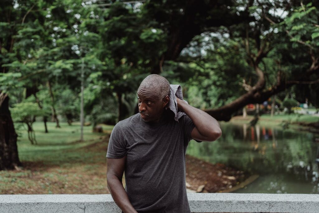 Man in Gray Crew Neck T-shirt Wiping His Sweat