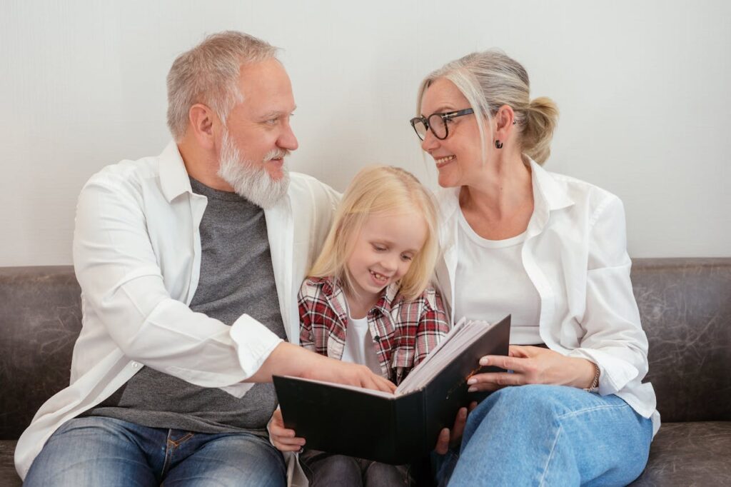 A Grandparents and Girl Looking the Album Together