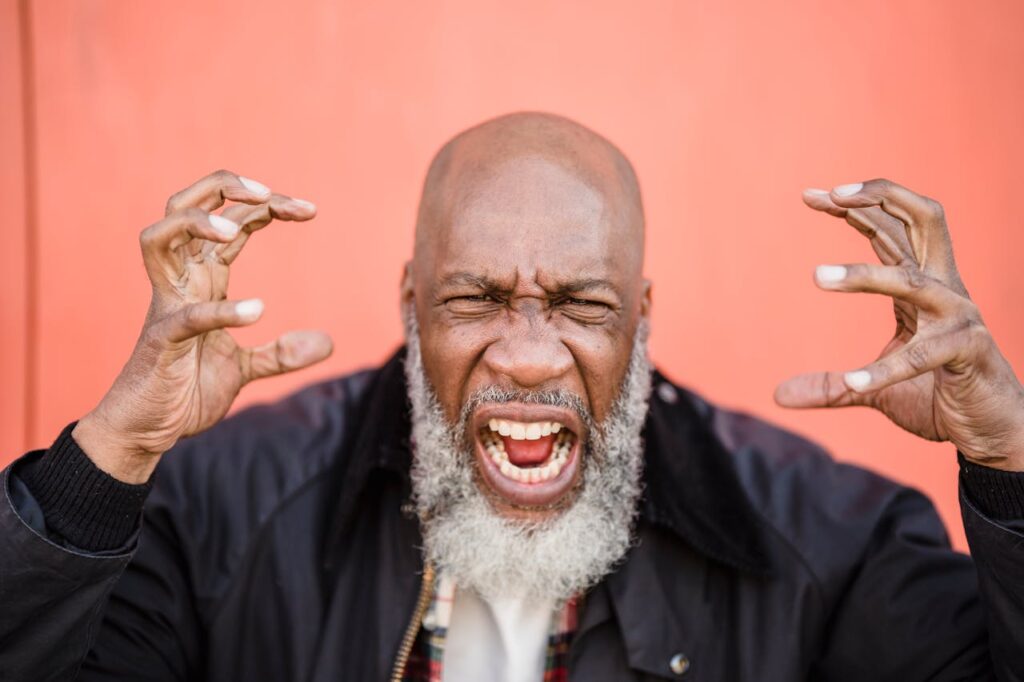 Close-Up Photo of a Frustrated Man with Gray Beard
