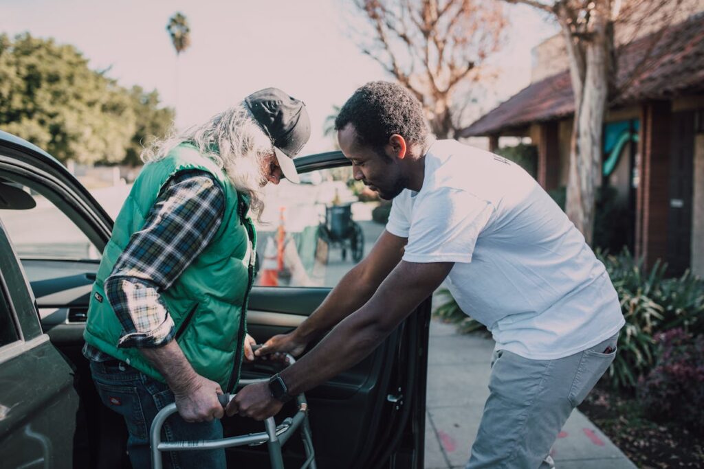 a black guy taking care of an old man