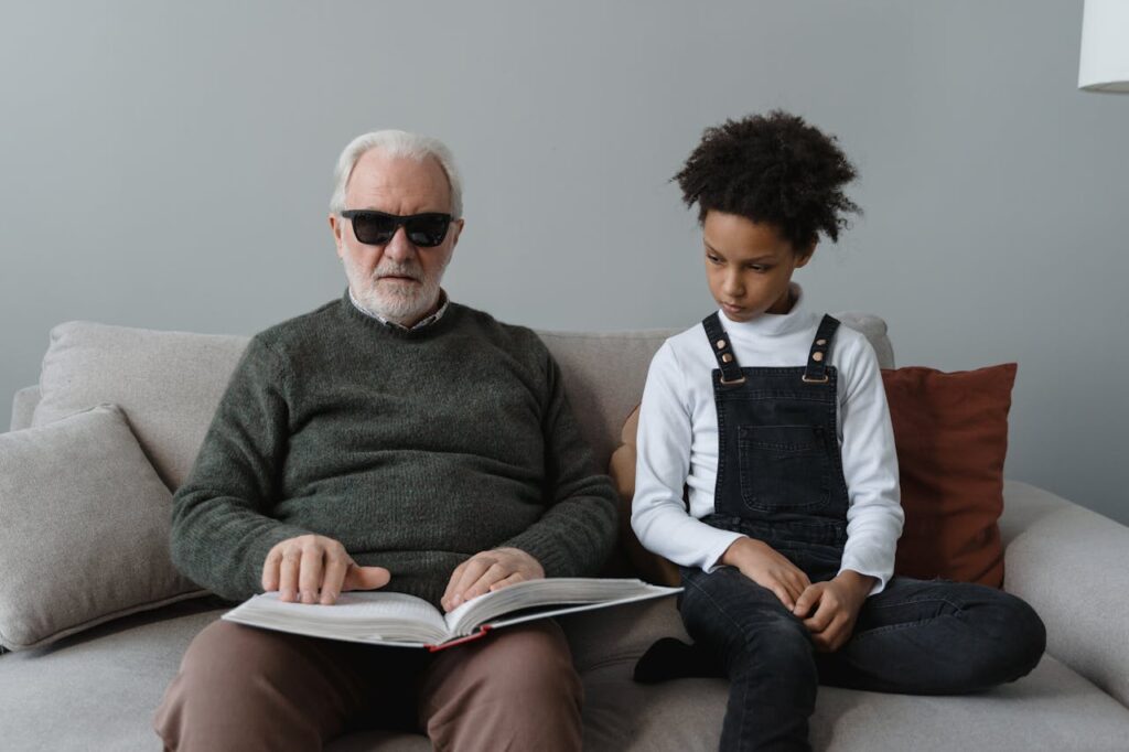 Girl Sitting on Sofa Beside an Elderly Man