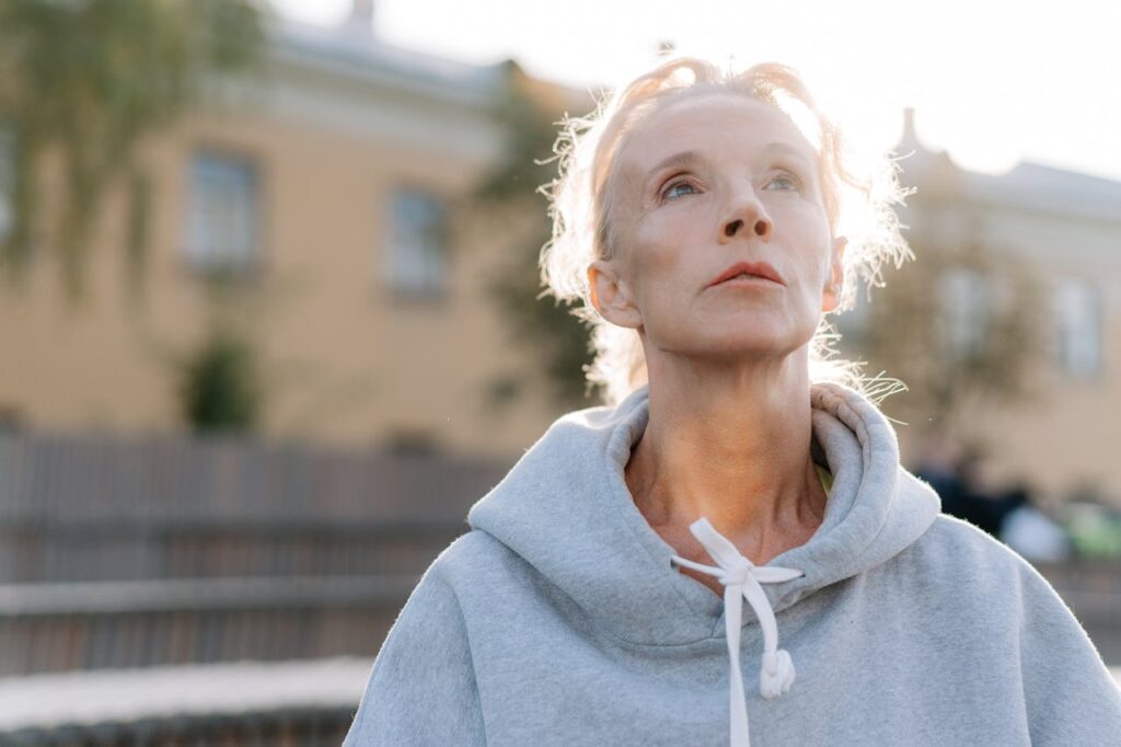 A Woman in a Hoodie Looking Up