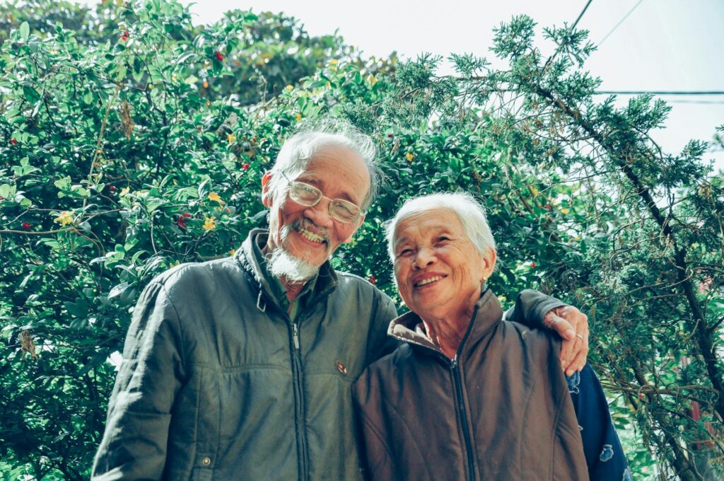 Senior_couple_enjoying_a_joyful_moment_together_in_a_lush_garden_setting,_exuding_love_and_happiness..Tristan_Le