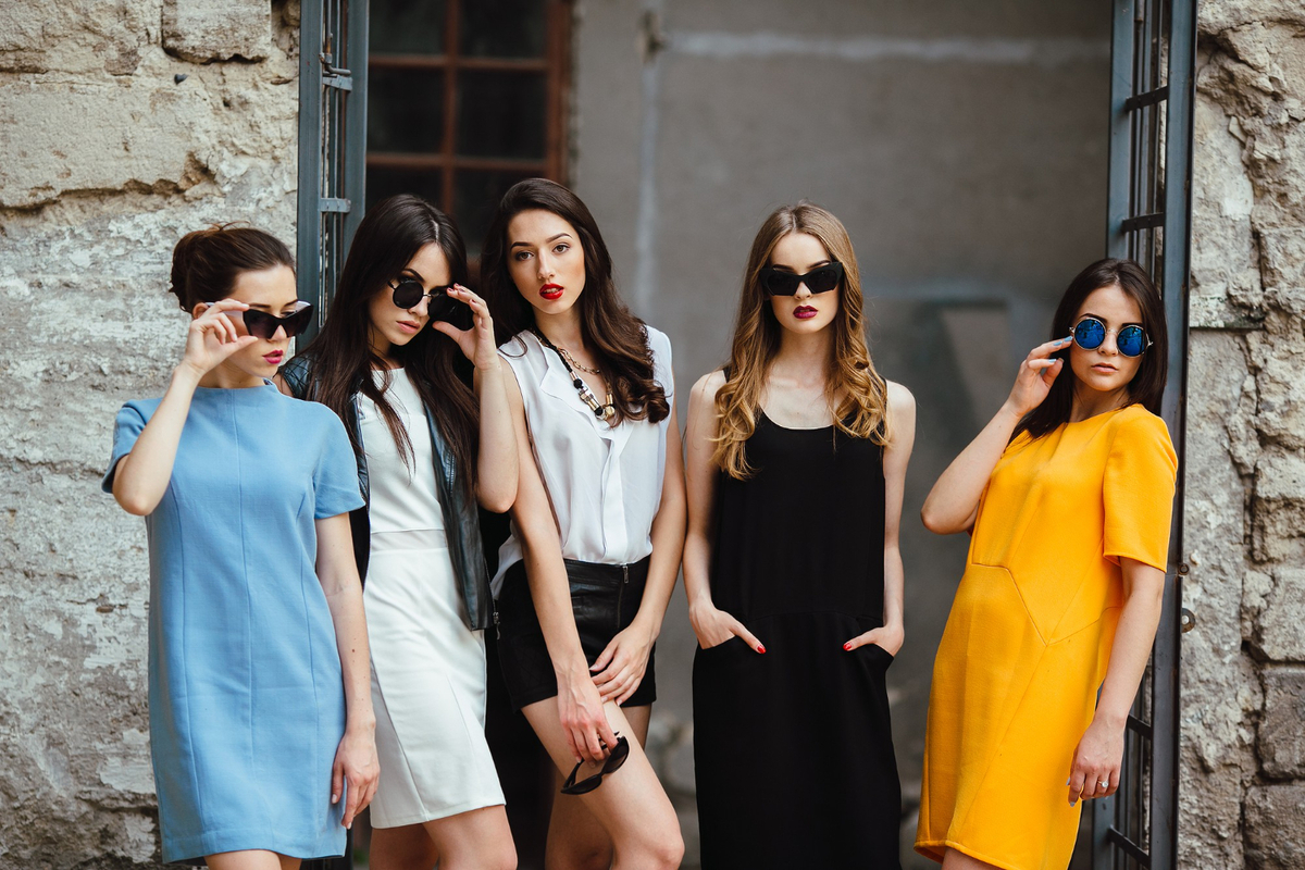 Five young beautiful girls posing against of an abandoned building