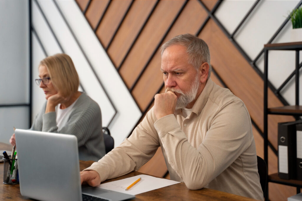 Senior people in school during class with laptop computer