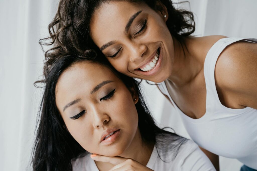 Two women sharing an intimate moment of togetherness, showcasing diversity and friendship.
