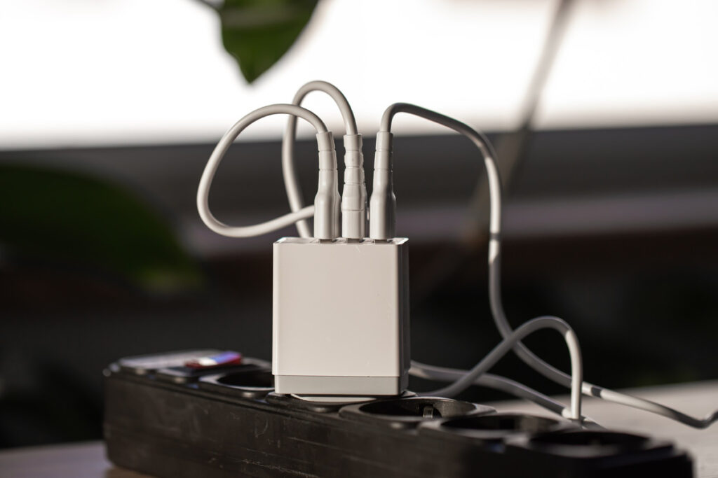 USB charging for gadgets on a blurred background of the room, close-up. The concept of technology in everyday life.
