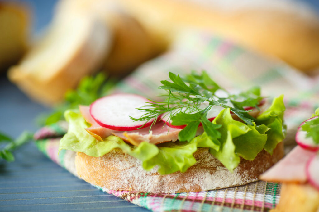 Sandwich with lettuce, ham and radish