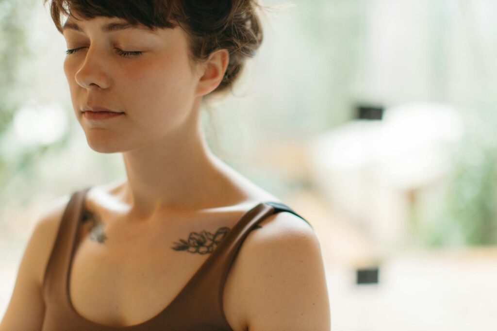 Woman_with_closed_eyes_meditating_indoors,_symbolizing_tranquility_and_focus..Anastasia__Shuraeva