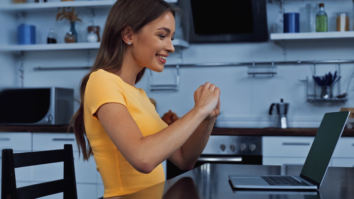 girl showing heart on computer