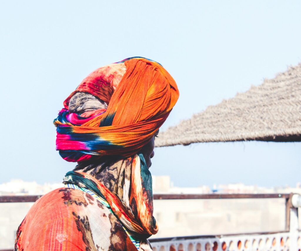 man wearing orange and pink turban