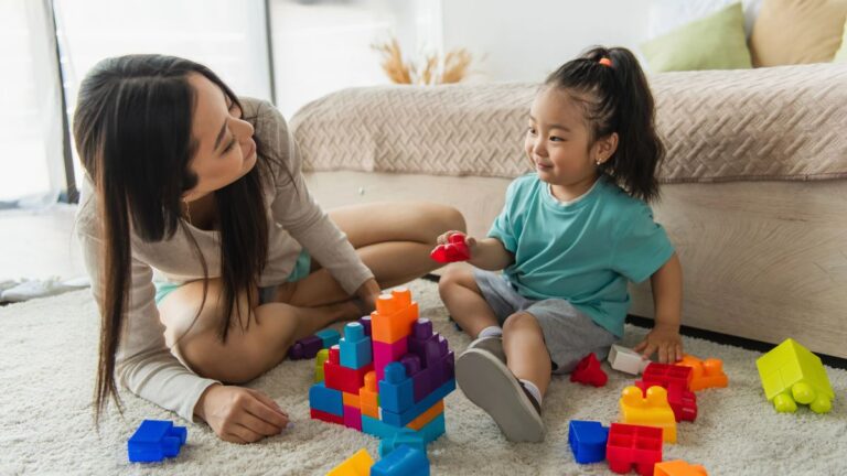 mom and little girl playing with blocks