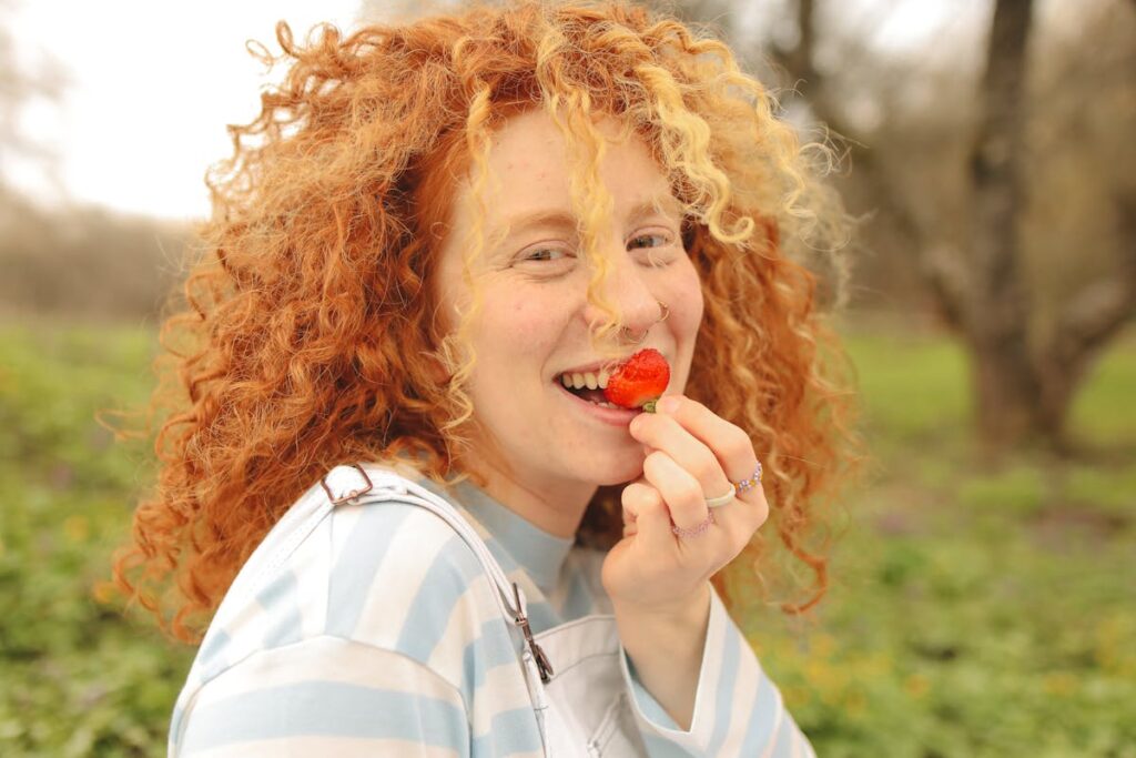 A women eating a strawberry