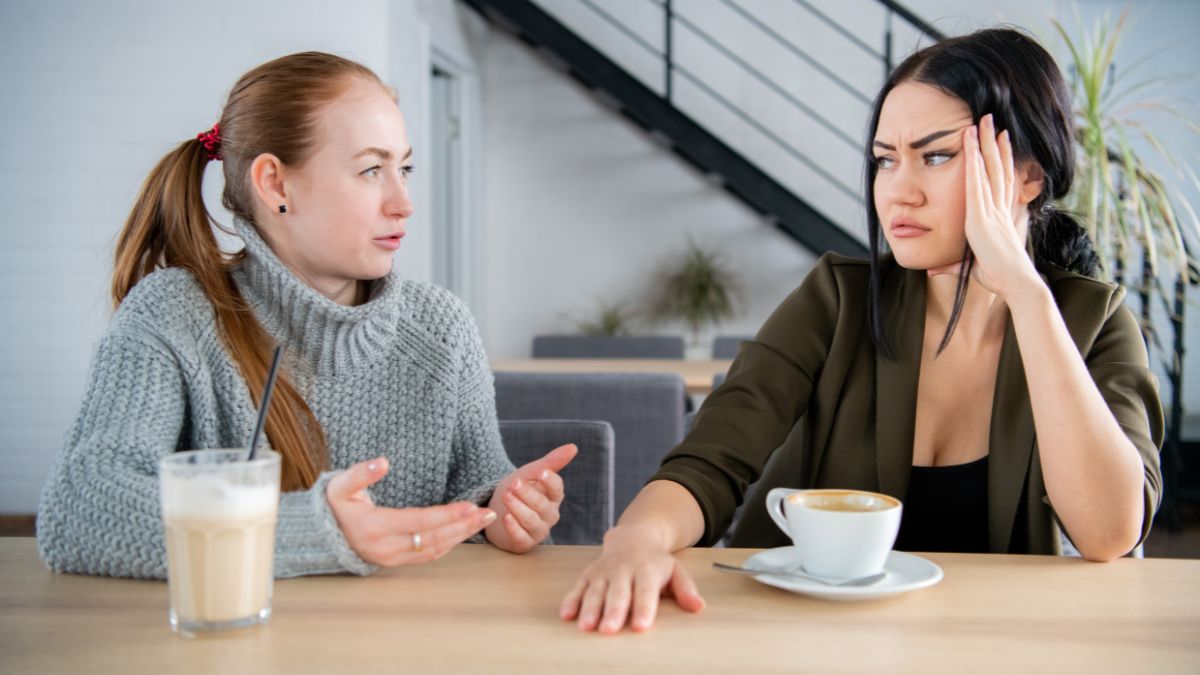 upset friends talking at table