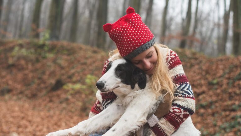 woman hugging dog outside