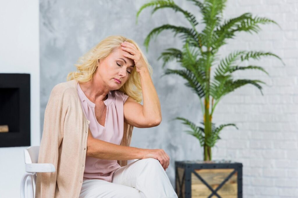Old lady having a headache