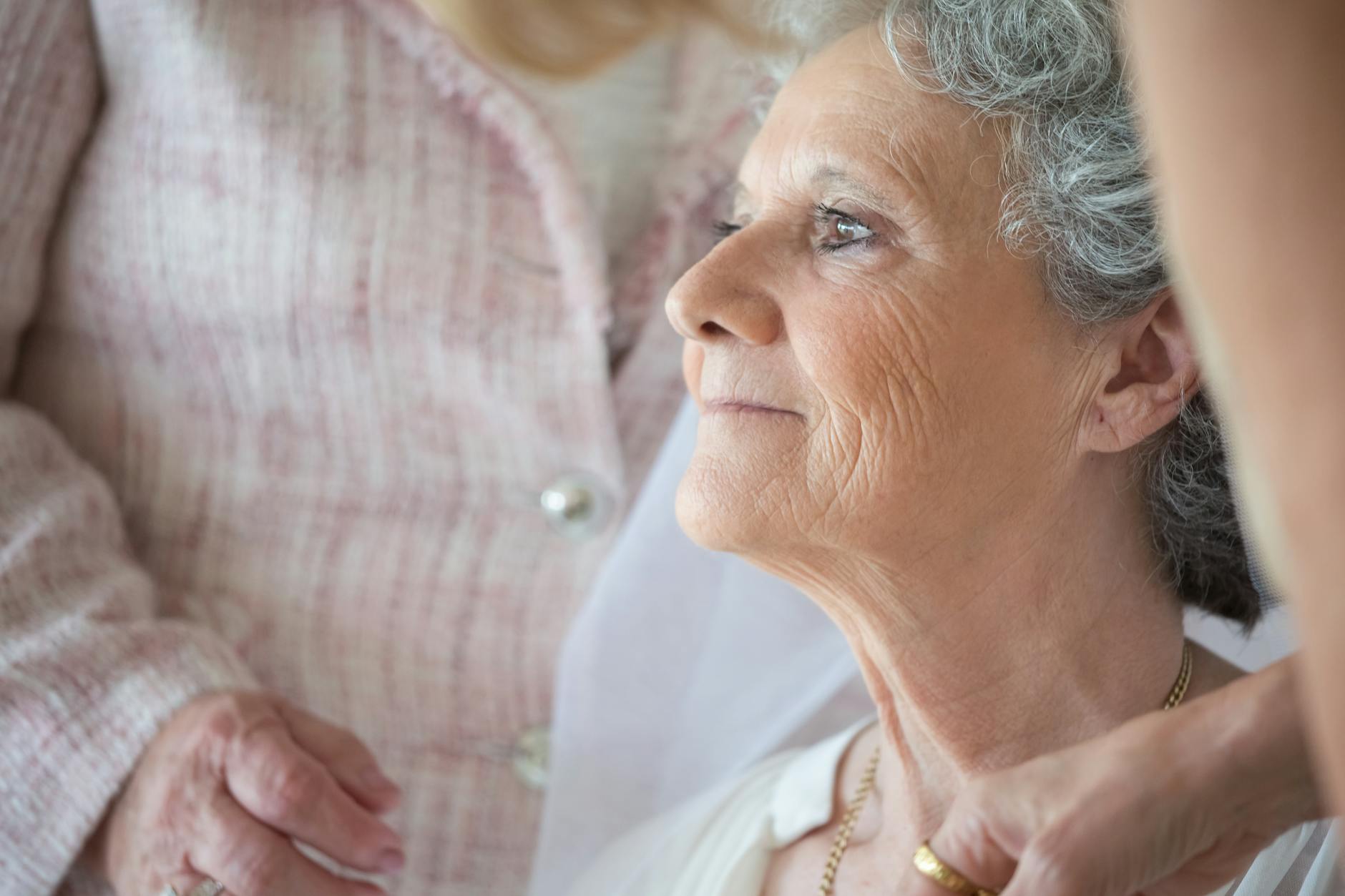 Close up of a serene elderly woman with gray hair in a peaceful indoor setting.Kampus Production
