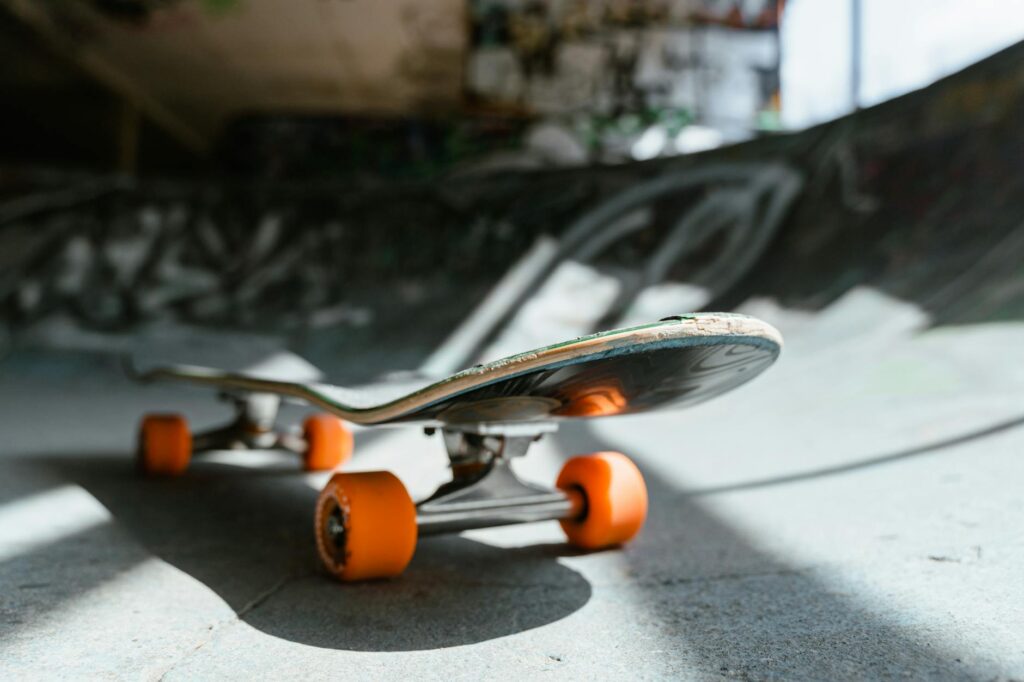 Detailed view of a skateboard in an urban skate park setting, perfect for sports enthusiasts.