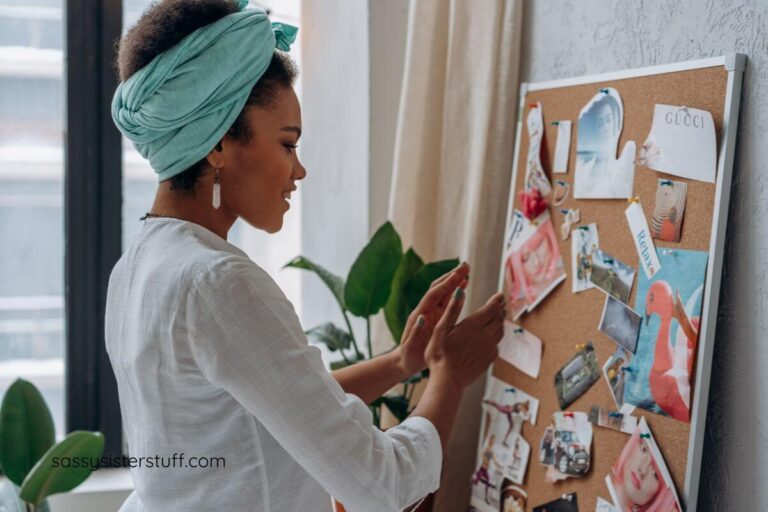 a woman reflects on her vision board to decide if she wants to make changes.