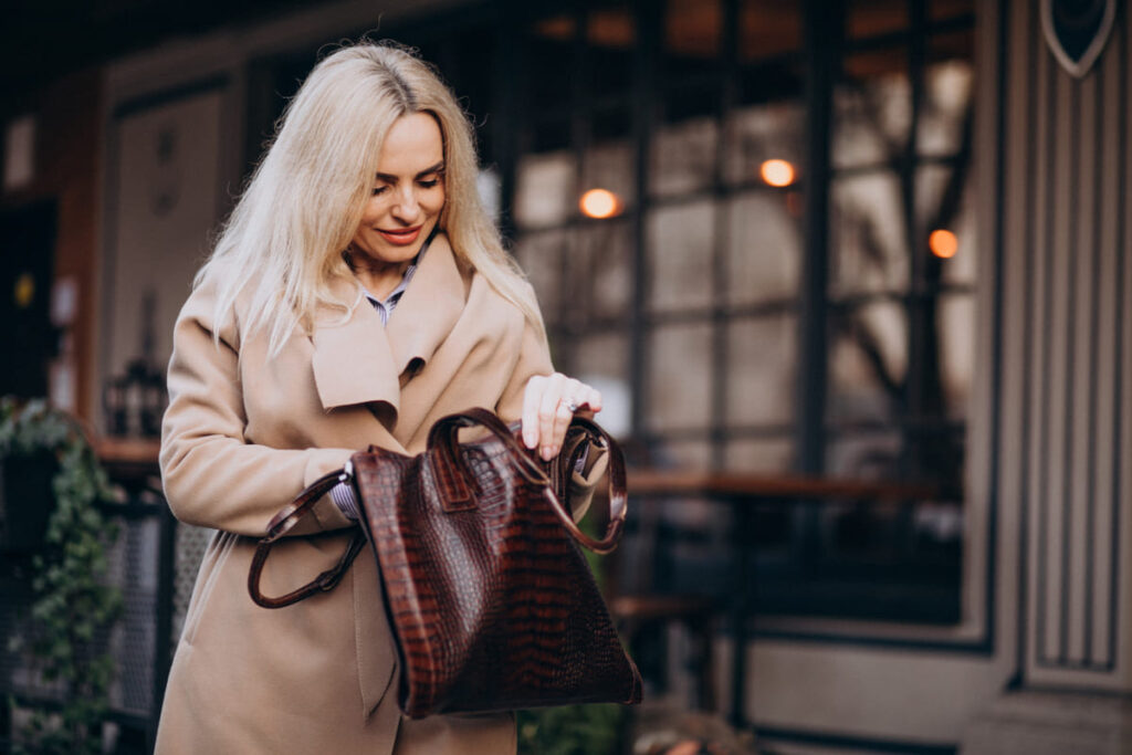 Elderly woman in a coat outside the cafe