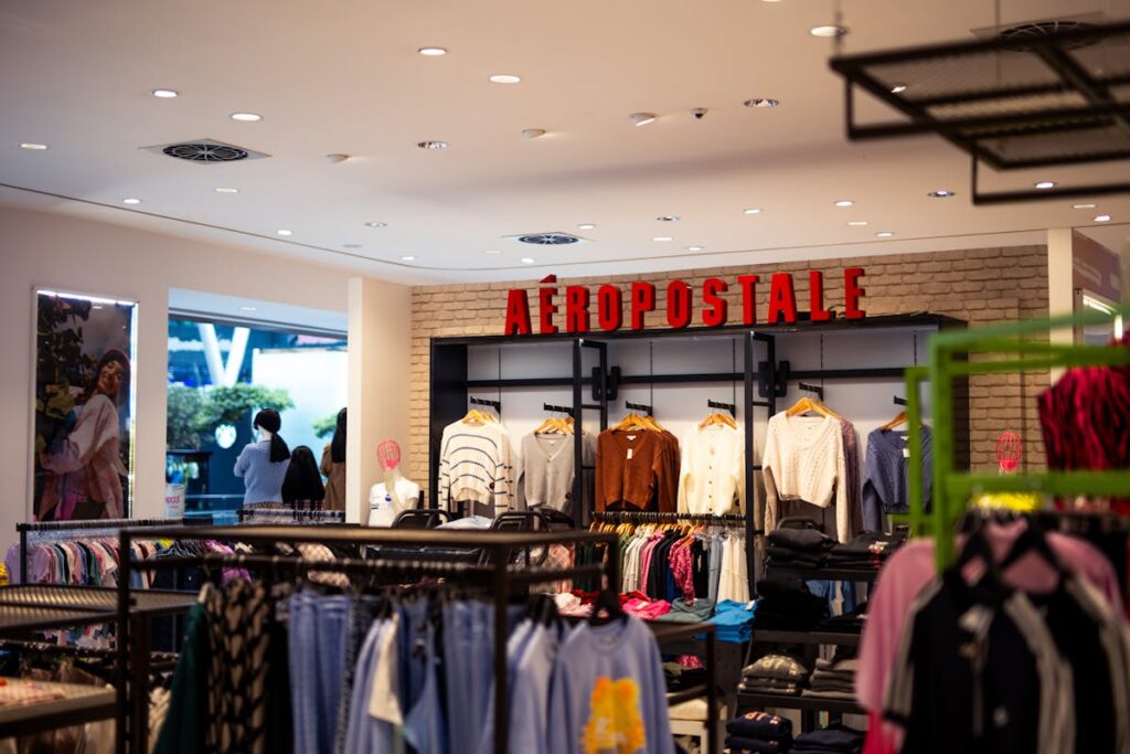 A clothing store with clothes hanging on racks