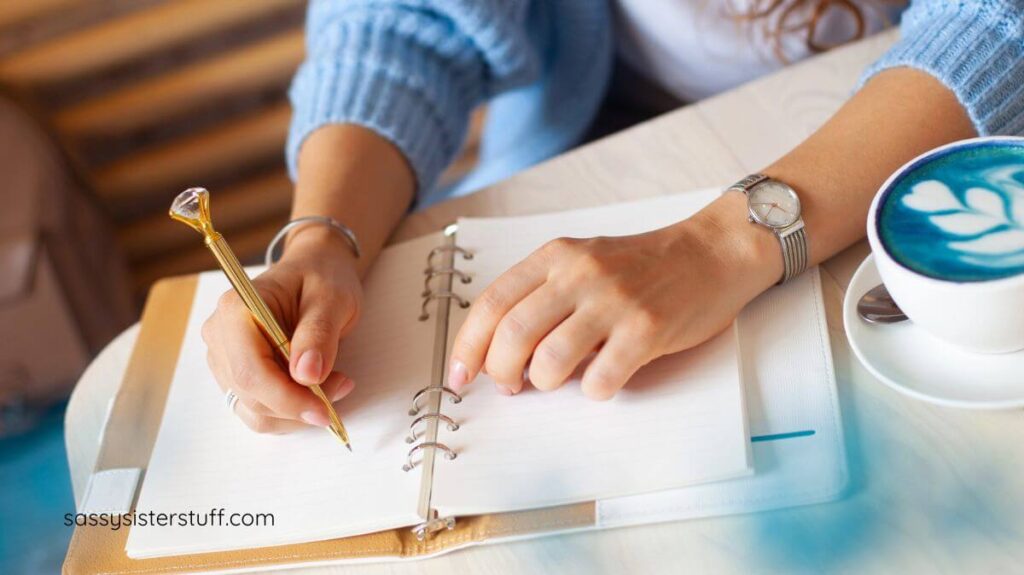 top view of a woman writing in her journal.