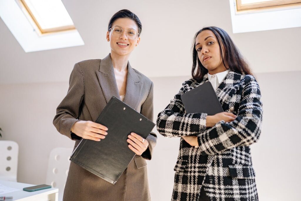 Businesswomen Standing with Catalogs