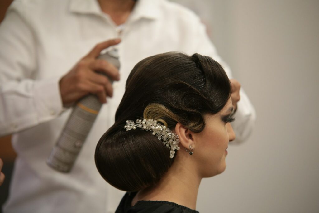 woman styling hair with pearl hair clips