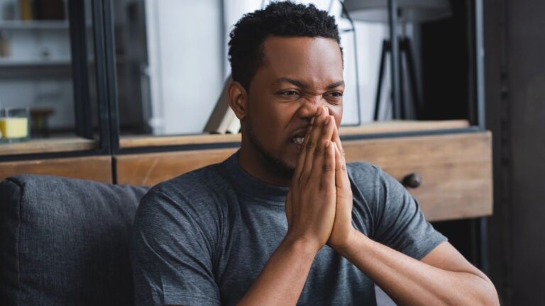 man looking stressed with hands on face
