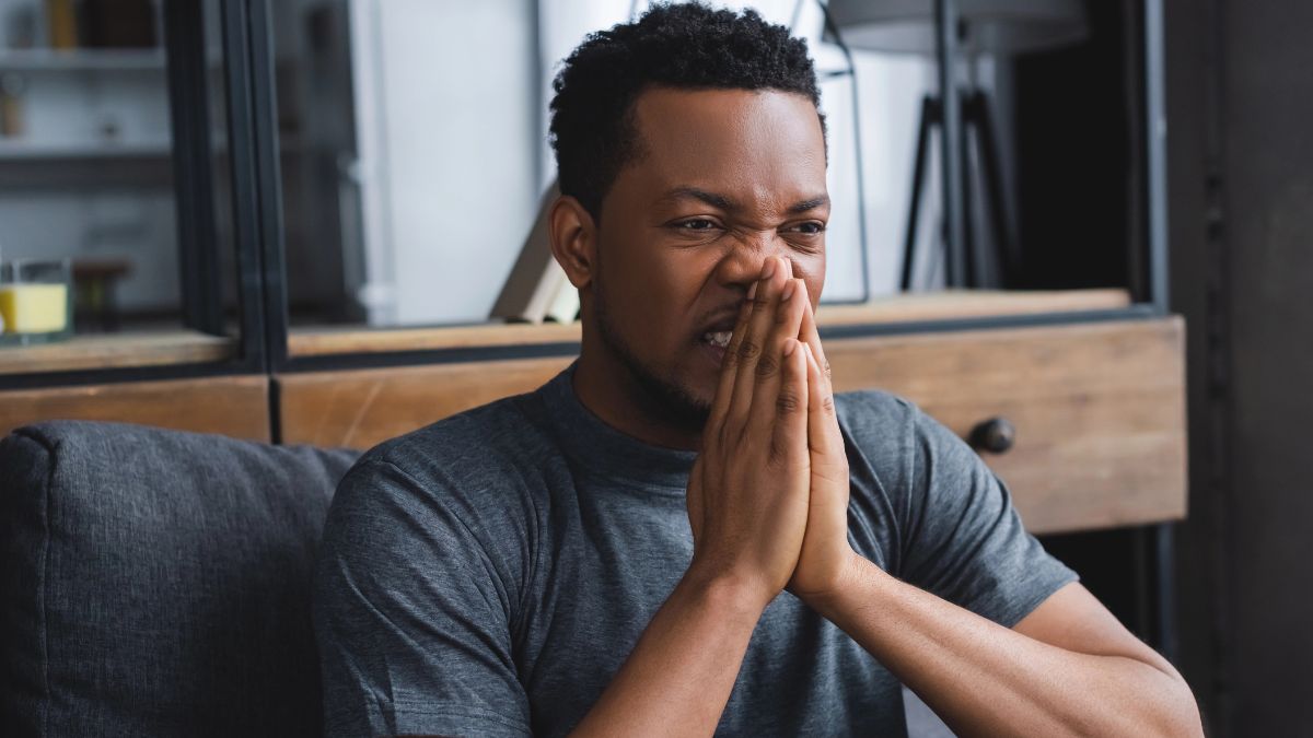 man looking stressed with hands on face