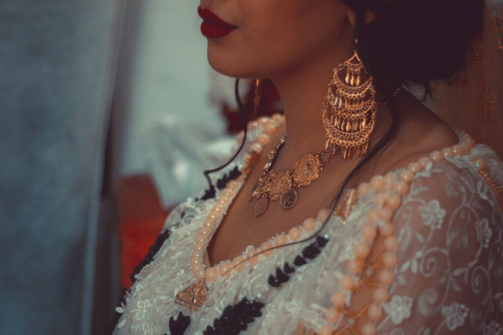 woman wearing solid gold hoop earrings,