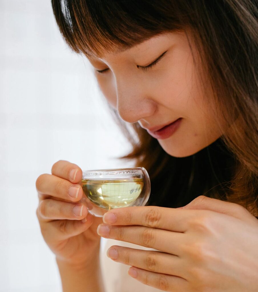 Adolescent Girl Enjoying Cup of Green Tea