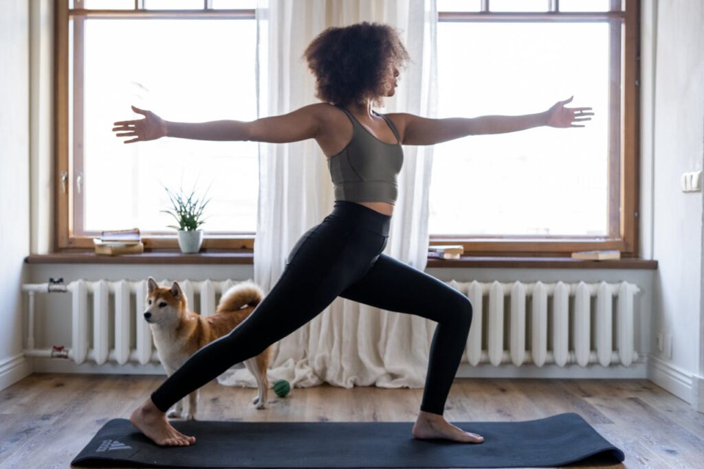 woman doing downward dog yoga stretch at home