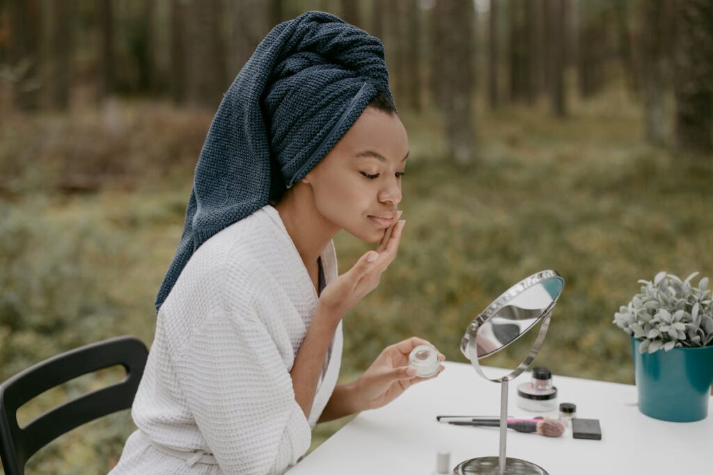 Woman applying face cream on her face