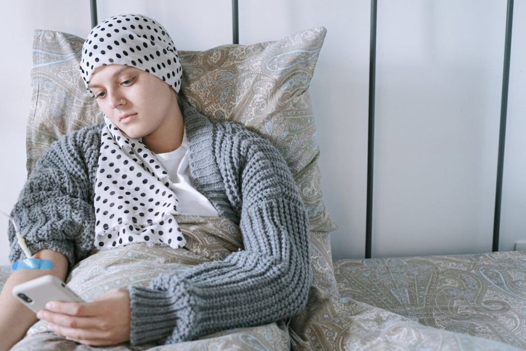 Woman in White and Black Polka Dot Hijab Sitting on Sofa