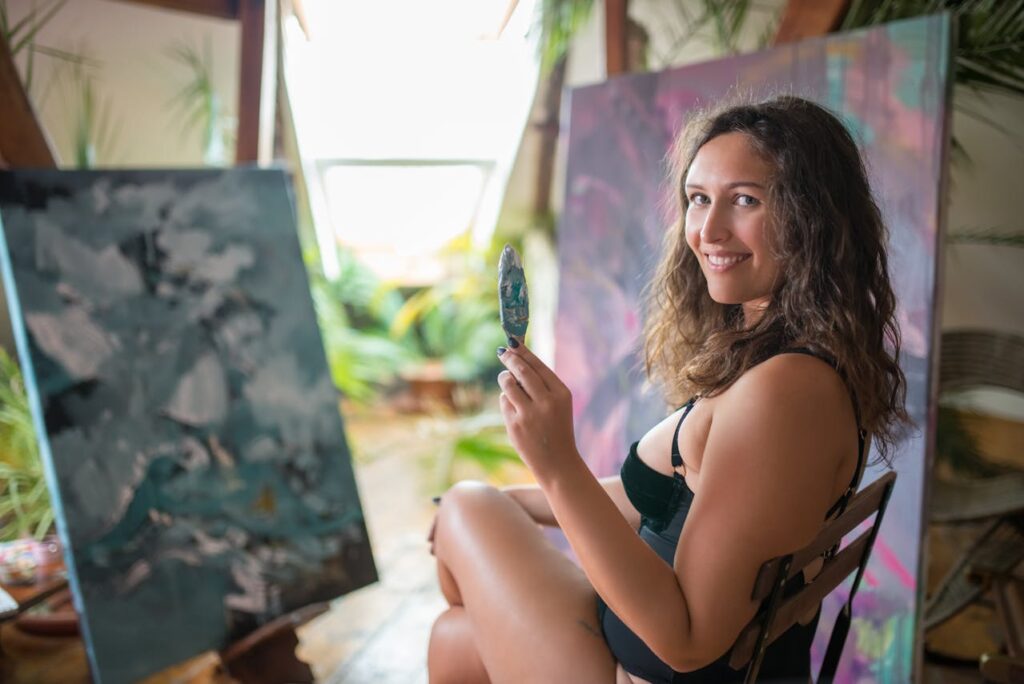 Woman in Black Tank Top Holding Paint Spatula