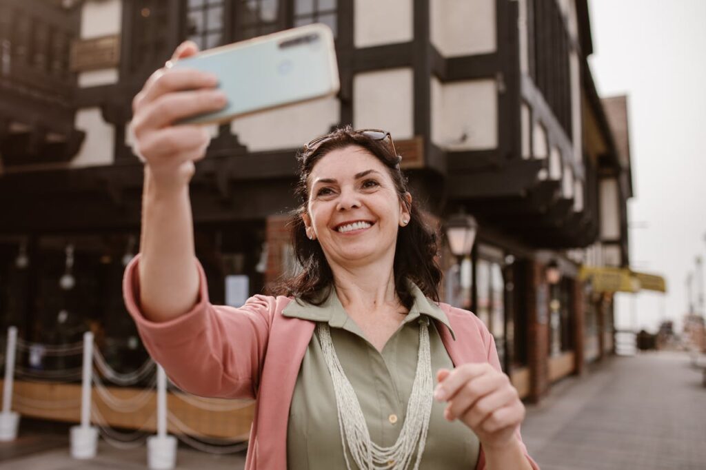 A Woman in Pink Blazer Taking Selfie