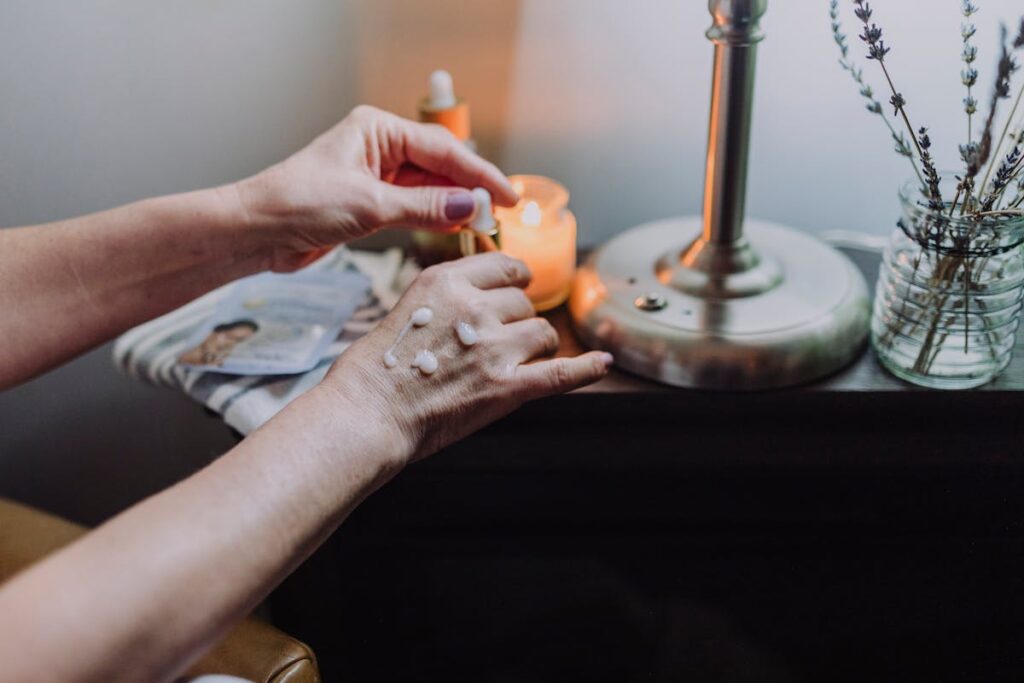 Person Applying Moisturizing Cream on Hands