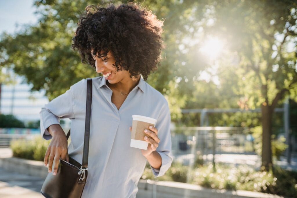 Photograph of a Woman Putting Something in Her Purse