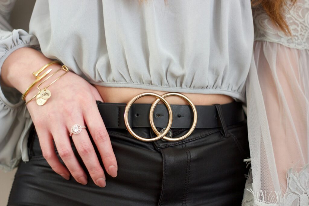 woman wearing leather belt with gold buckle
