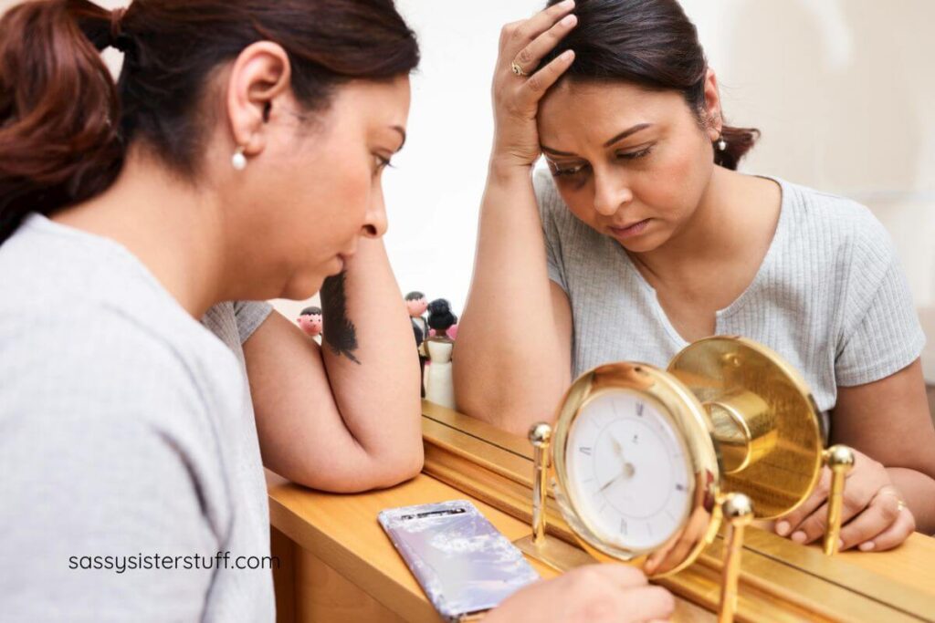 a womans midlife crisis leaves her holding her head and looking at a clock hopelessly.