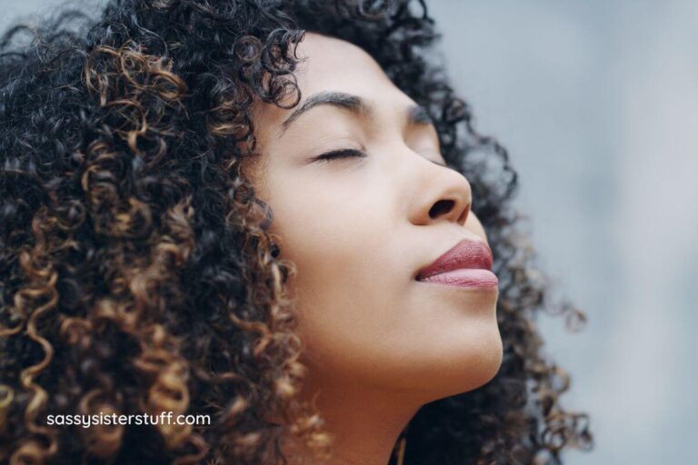 close-up of woman taking a moment to close her eyes and breathe to find calm in the chaos.