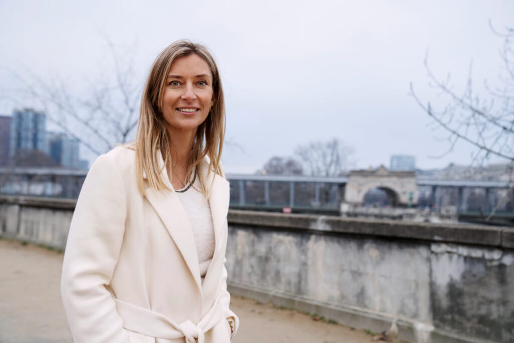 Full length of smiling woman sitting outdoors
