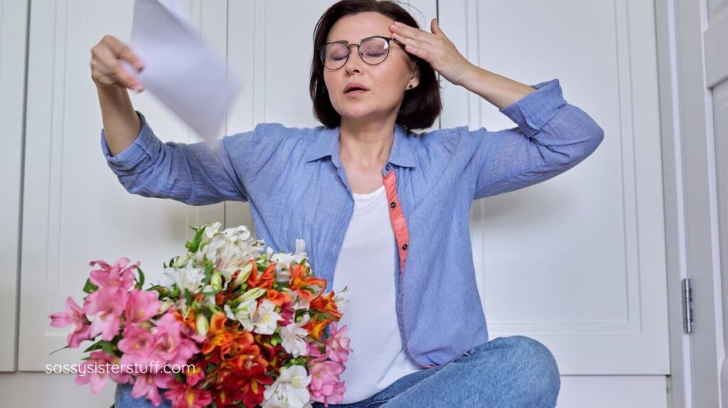 middle aged woman having a hot flash.